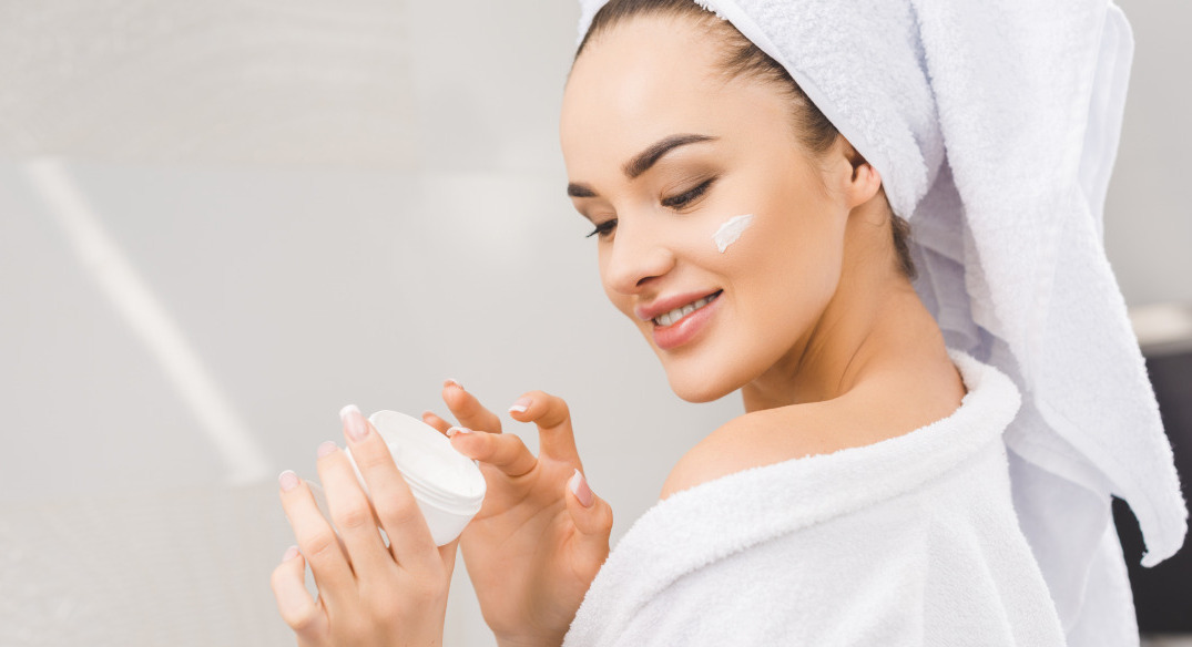 Applying essential oil cream to skin